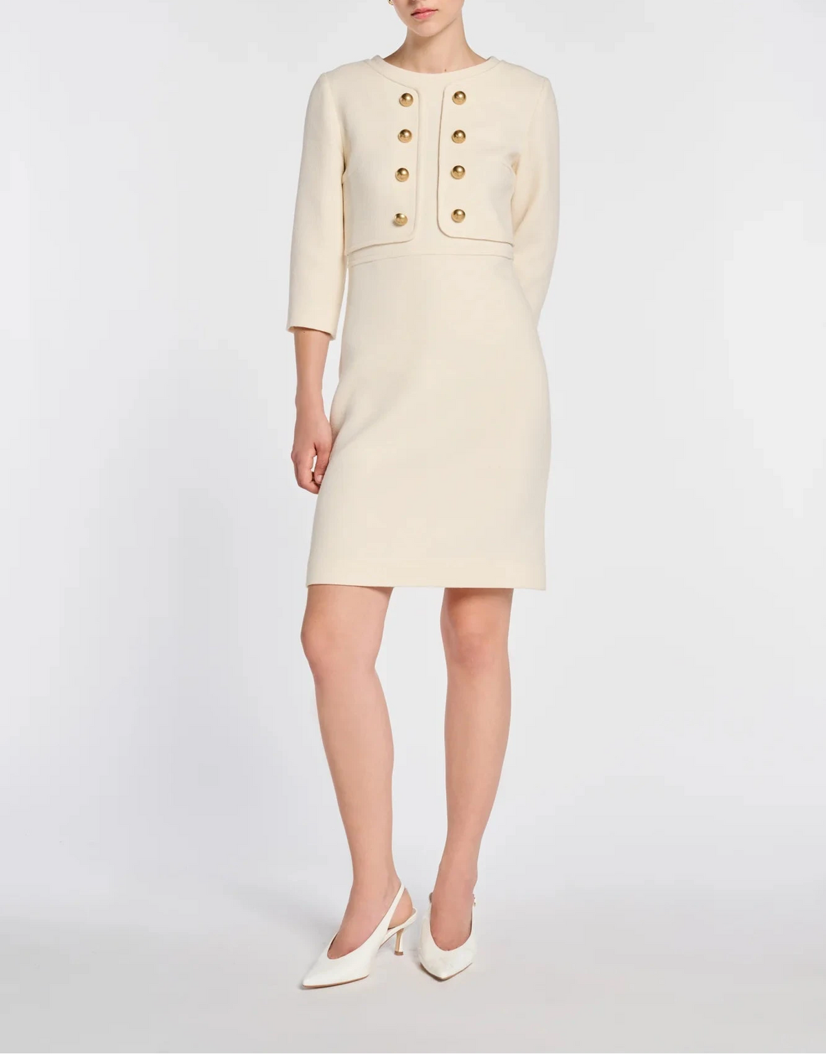 Model wearing Weill ivory wool illusion dress with ivory slingback heels