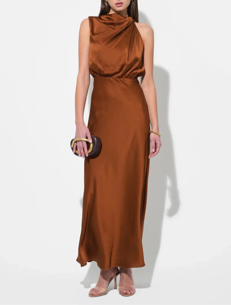 Copper satin asymmetric cowl halter maxi dress with sleek column silhouette—formal evening style at BTK COLLECTIONS.