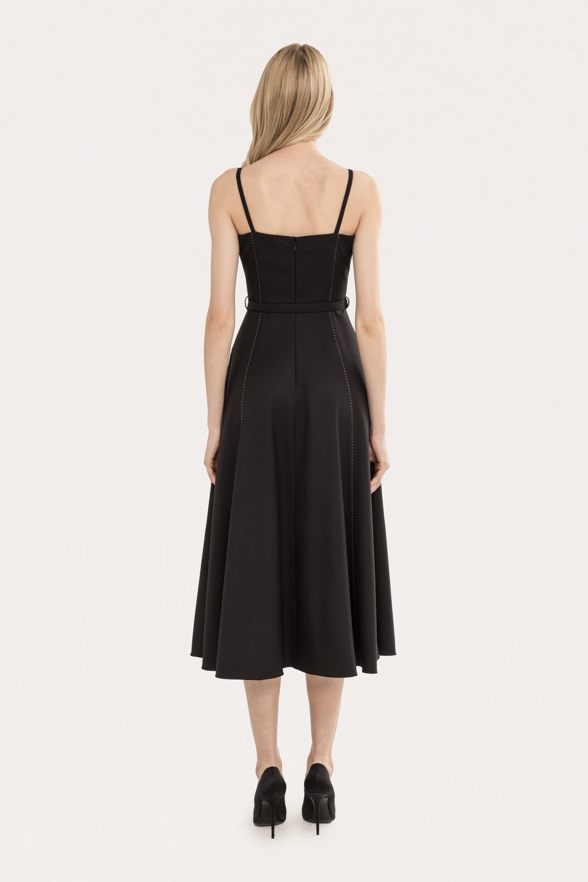 Back view of a black sleeveless belted midi dress with slim straps and an elegant A-line silhouette