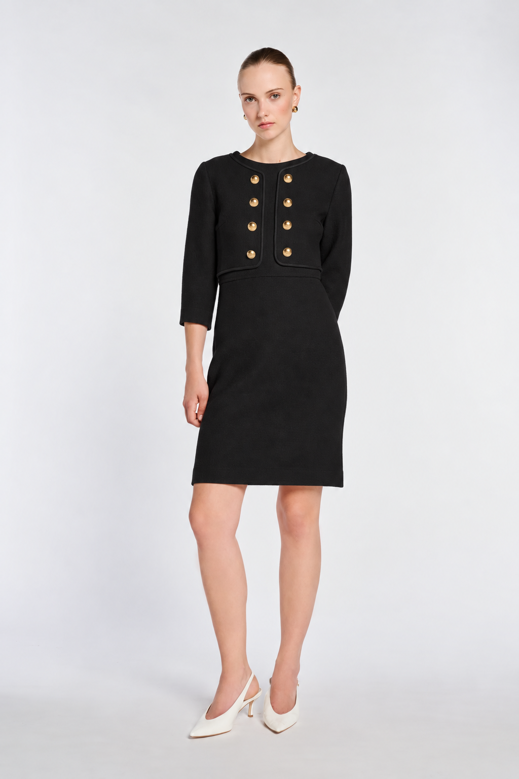 Model wearing the Weill Paris black wool dress with three-quarter sleeves and ivory slingback heels