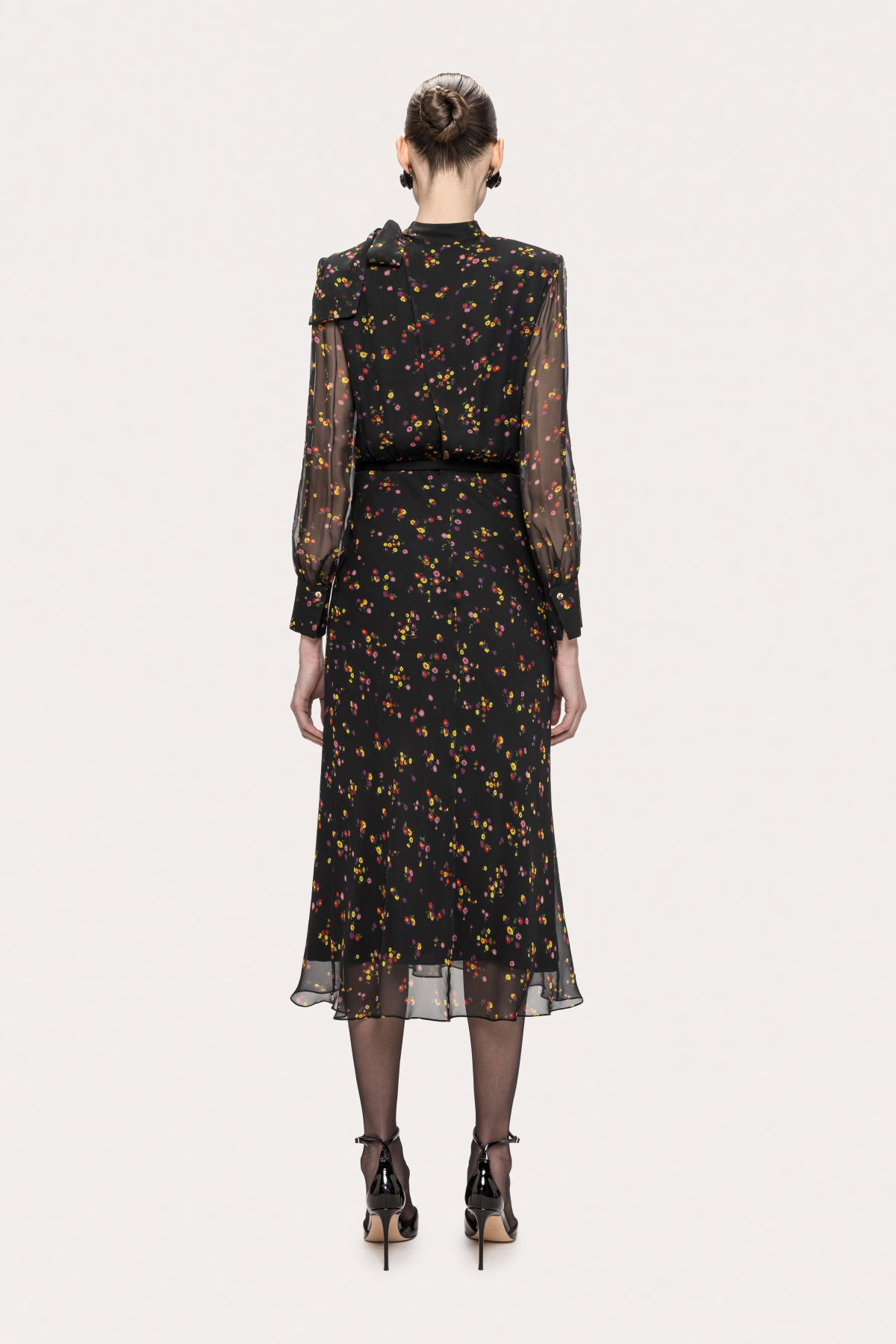 Back view of the NISSA black floral silk midi dress with sheer sleeves and softly flared midi skirt