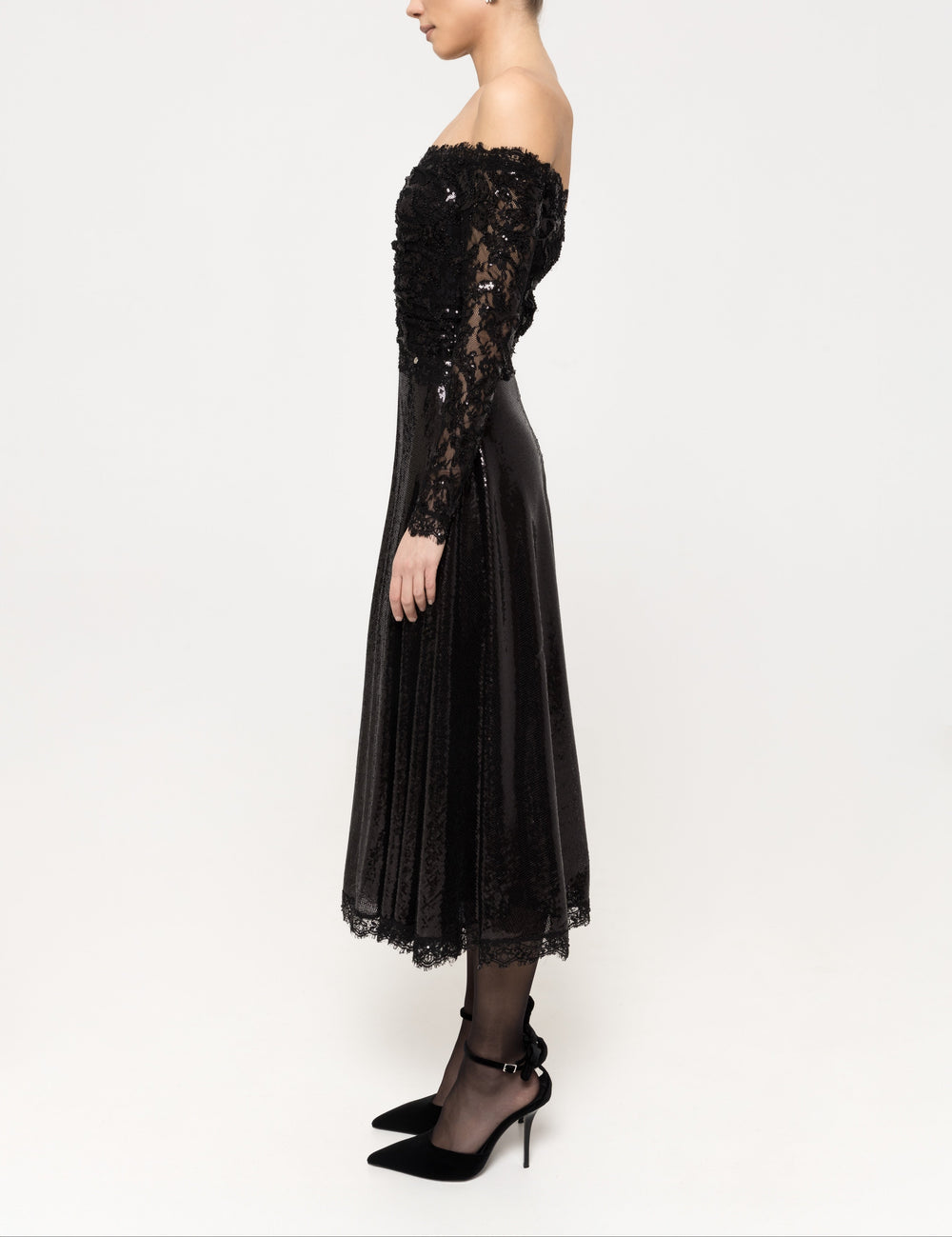 Side view showing fitted, fully sequined lace bodice and sleeves with flared sequin midi skirt.