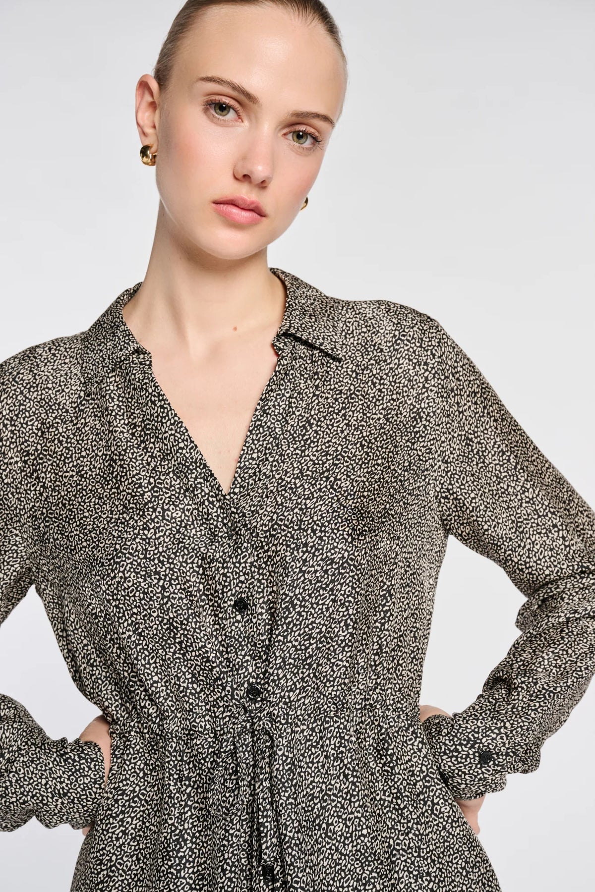 Close-up of the micro leopard print, shirt collar and button front on the Weill Paris black and ivory dress.