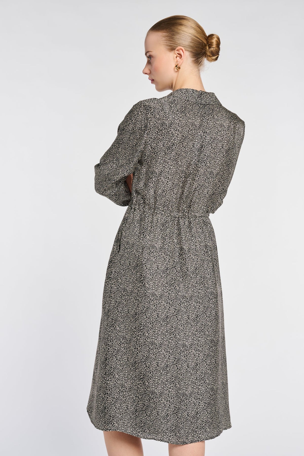 Angled back view of the Weill Paris printed shirt dress showing the collar, flowing fabric and waist gathers.