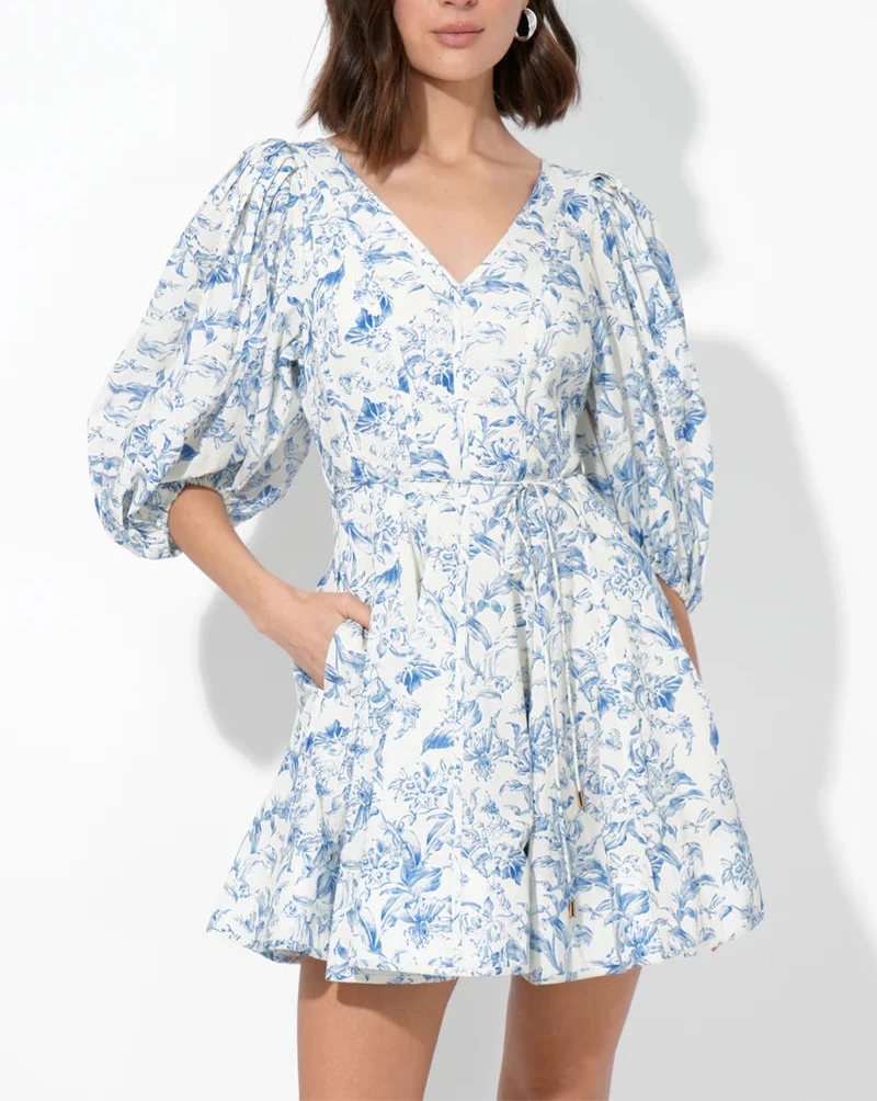 Front view showing V‑neckline, voluminous elbow‑length puff sleeves and fit‑and‑flare silhouette in blue toile floral