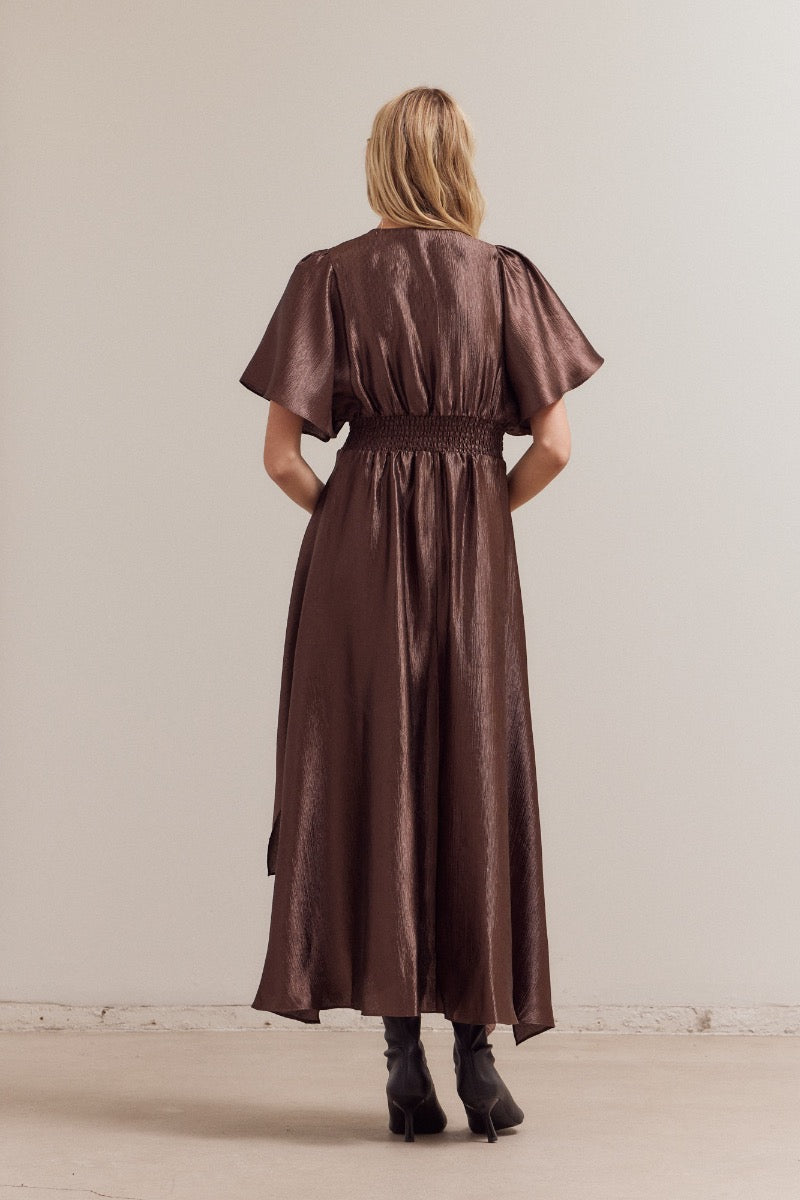 back view of dark chocolate asymmetrical satin maxi dress