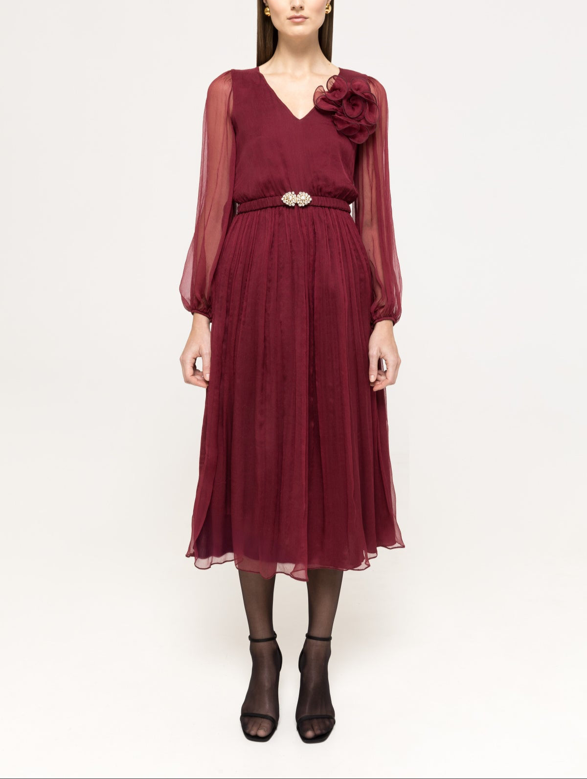 Burgundy V‑neck midi dress with sheer long sleeves, floral appliqué shoulder and crystal buckle belt
