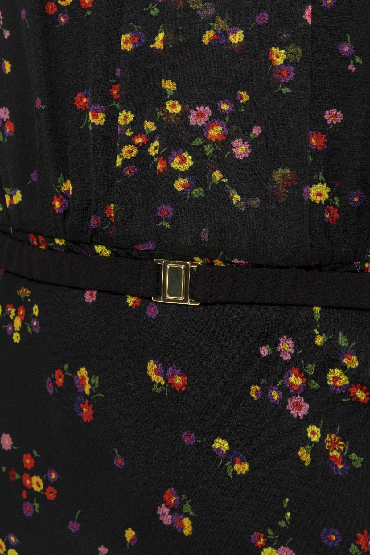 Close-up of the matching black floral belt with rectangular gold-tone clasp