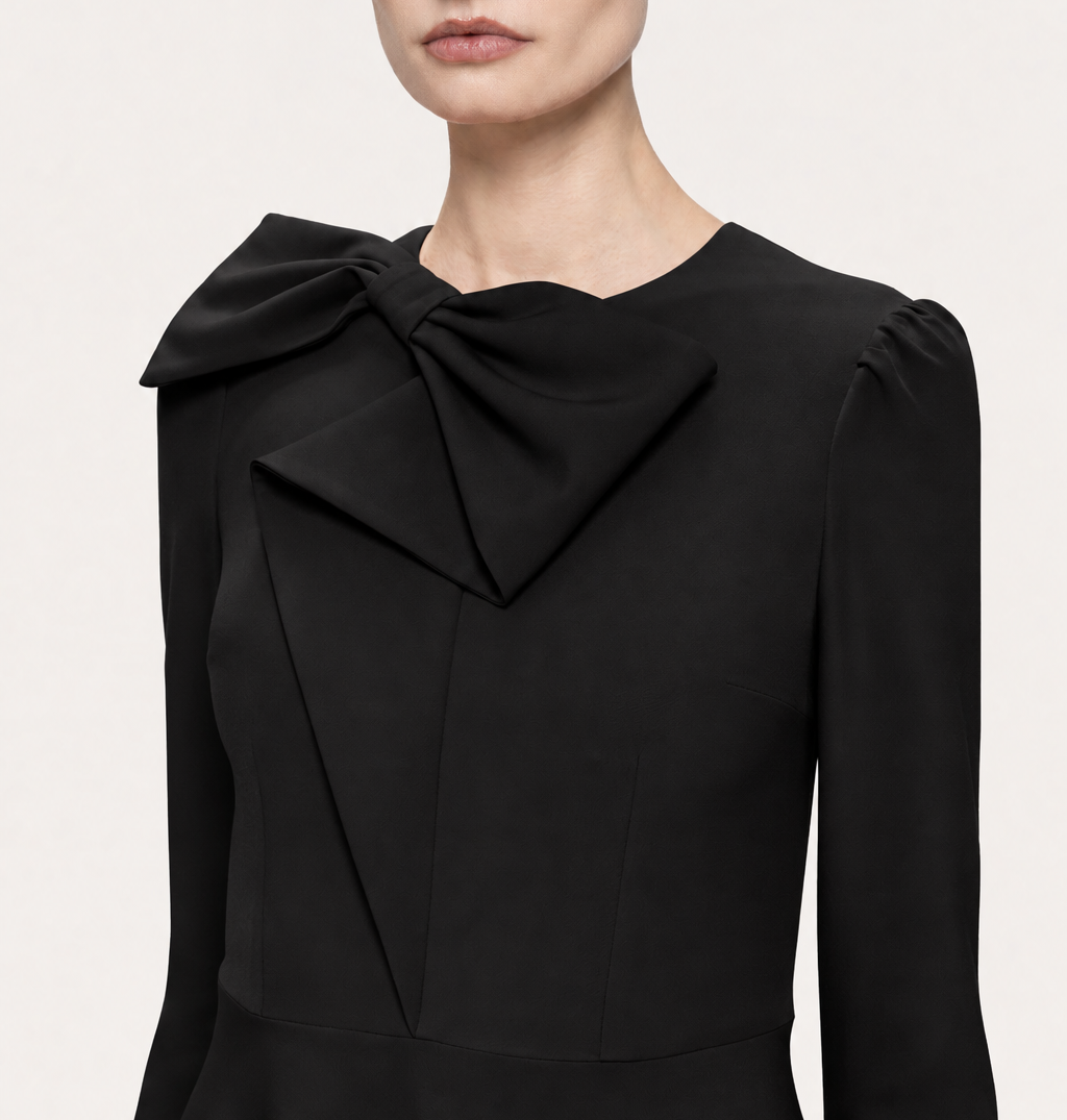 NISSA black midi dress bodice detail showing the neckline bow, shaping seams and softly gathered shoulders.