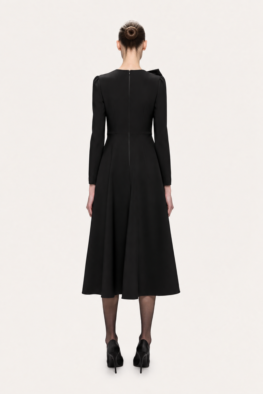 Back view of NISSA black A-line midi dress with a closed back, center zipper, defined waist and long sleeves.