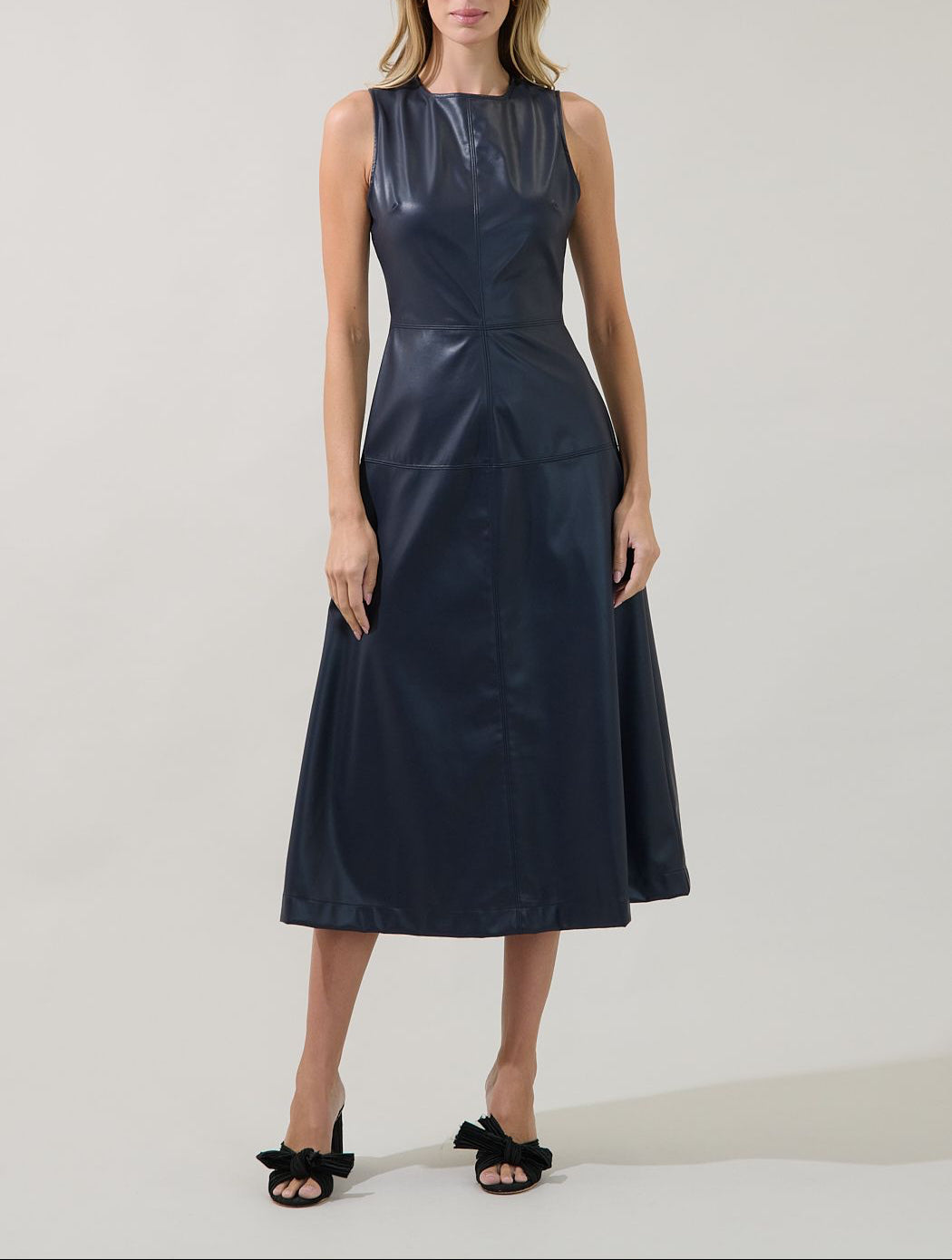 Front view of the Sugarlips Strella navy faux leather midi dress with a sleeveless bodice, defined waist and A-line skirt.