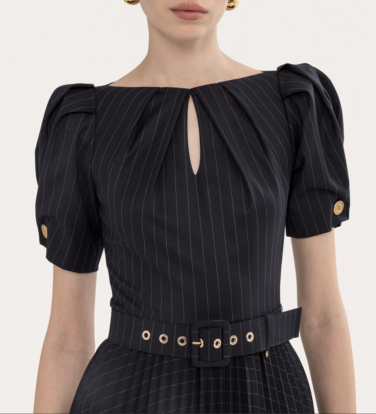 Close-up of black pinstripe bodice with puff sleeves, keyhole neckline, and belted waist detail