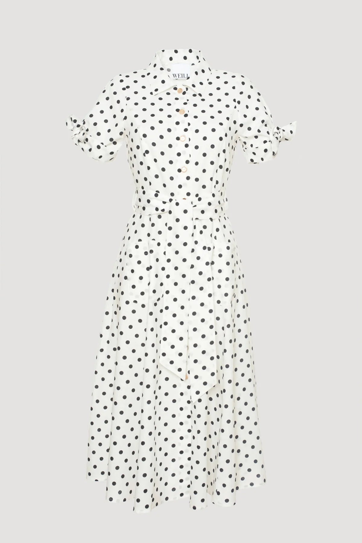White midi-length polka dot shirt dress with black dots, collar, button-down front, and tie sleeves