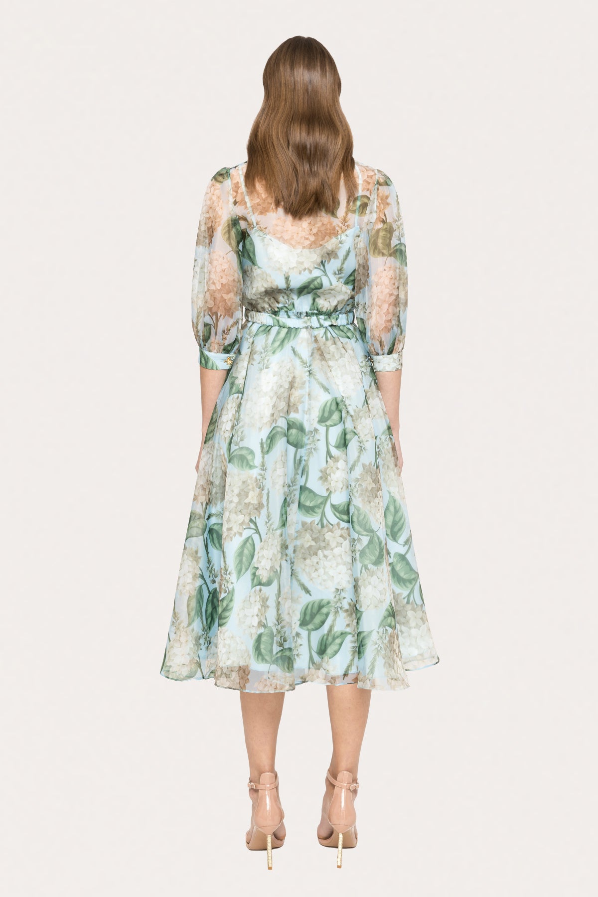 Back view of sage green floral organza midi dress with elastic waist and flowing A-line skirt, perfect for garden party or wedding guest
