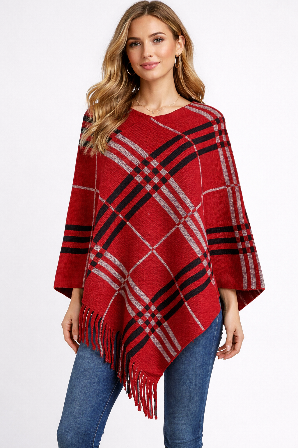 Woman wearing a red plaid poncho with black and gray stripes on a white background