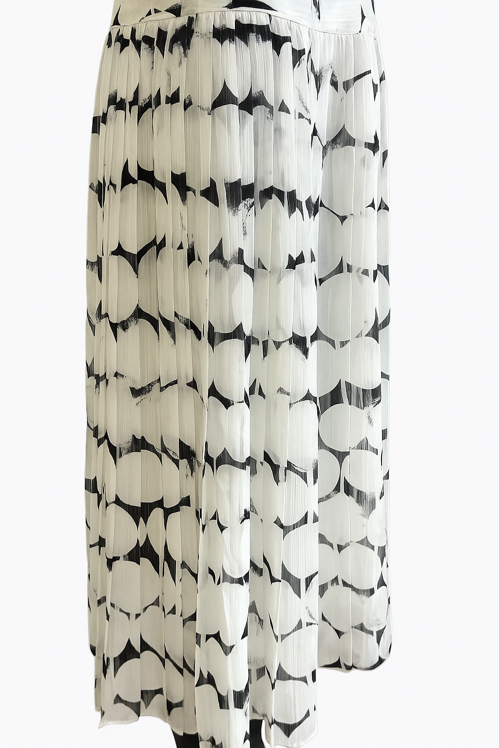 Side view of black and white abstract print chiffon midi dress showing fluid A-line silhouette and pleated skirt detail.