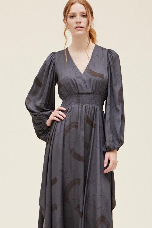 Grade & Gather Slate gray abstract satin dress showing the V-neck, smocked waist and long voluminous sleeves.