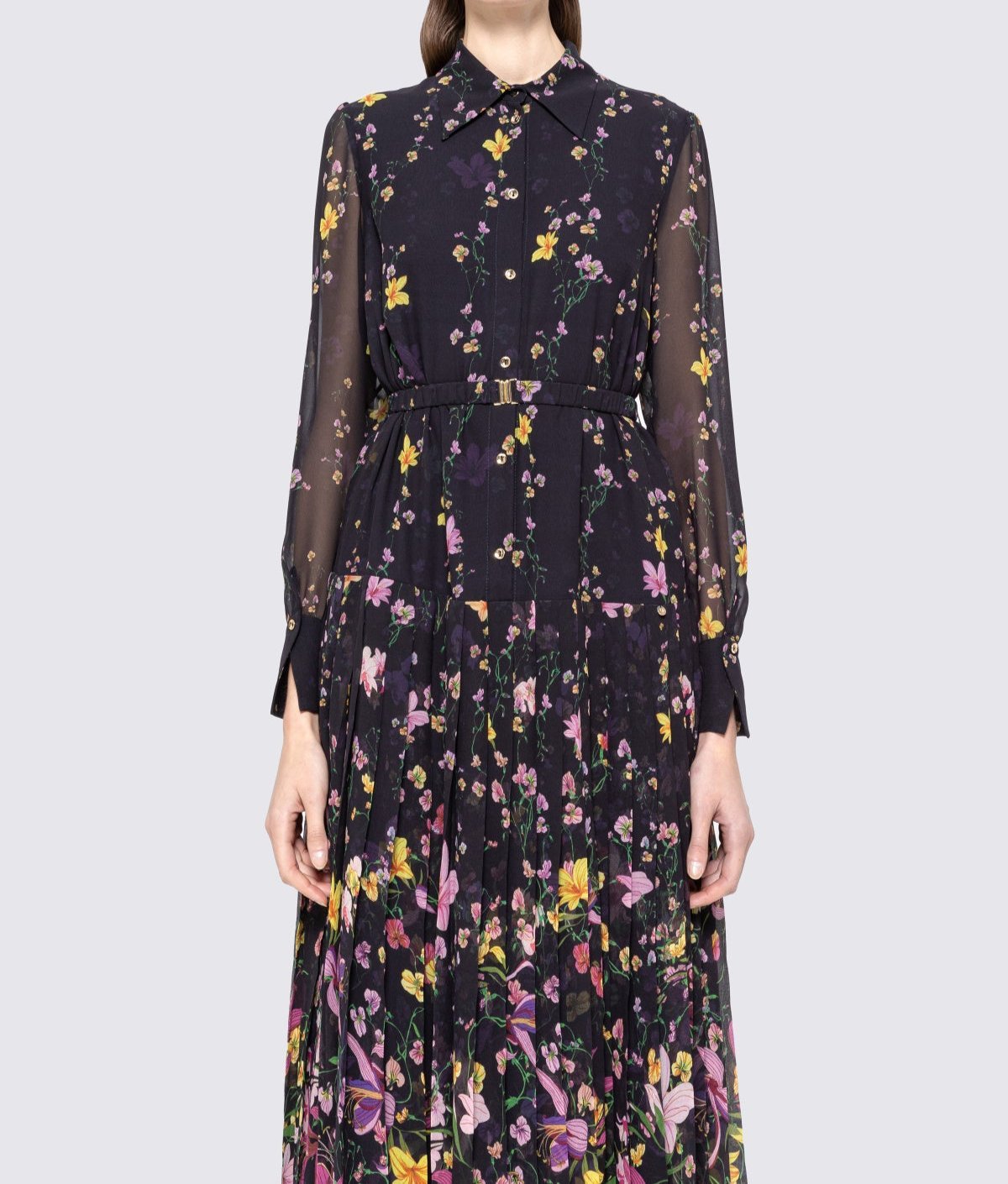 Close‑up of bodice and pleated skirt on black floral shirt‑collar midi dress with sheer sleeves and belt