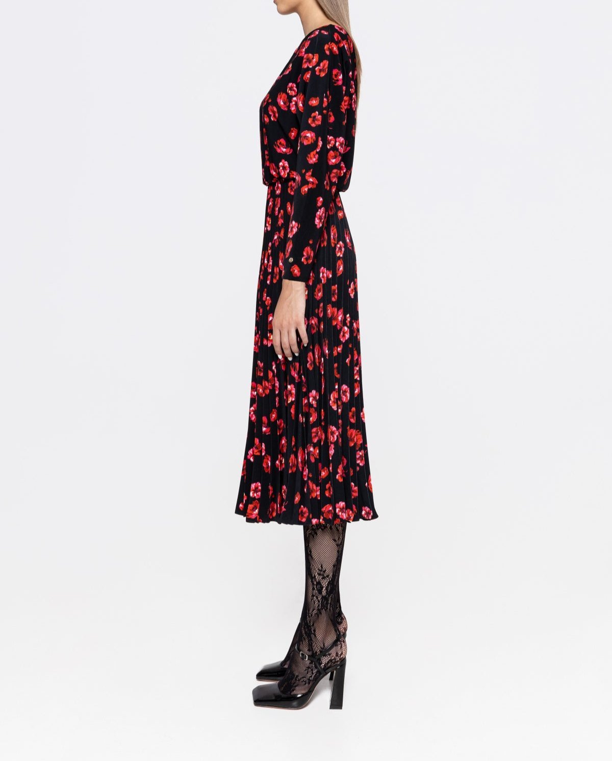 Side view showing A‑line pleated skirt and long sleeves on black red floral midi dress