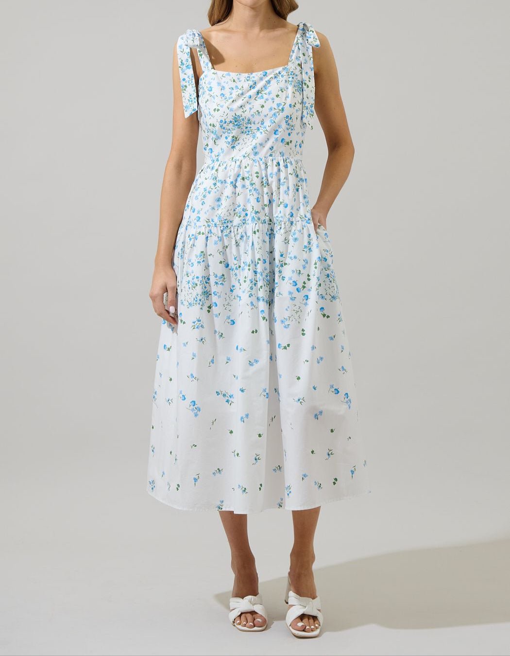 Blue floral white tie-shoulder maxi dress with gathered skirt, ideal for spring picnics and baby showers.