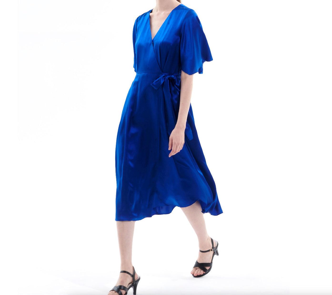 Royal blue silk wrap midi dress in motion showing fluid drape and elegant movement