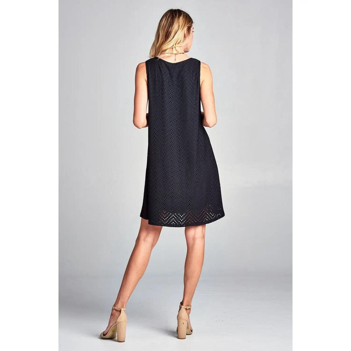 Back view of Renee C black mini dress showing the relaxed shape and openwork hem.