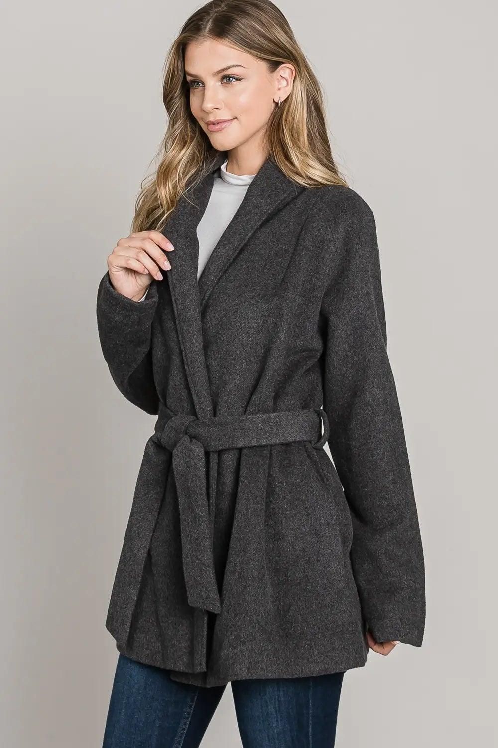 Angled view of the charcoal wrap jacket showing its lapel collar, matching waist tie and belt loop.
