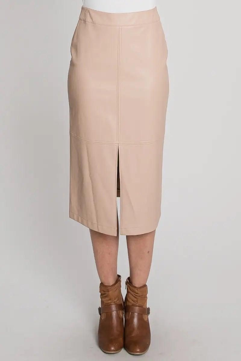 Close-up of nude faux leather skirt showing the waistband, front slit and panel stitching.