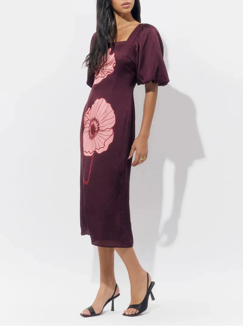 Side profile of the Alena Puff Sleeve Poppy Maxi Dress highlighting the puff sleeves, ruched bodice, and flowy A-line skirt in burgundy poppy print.