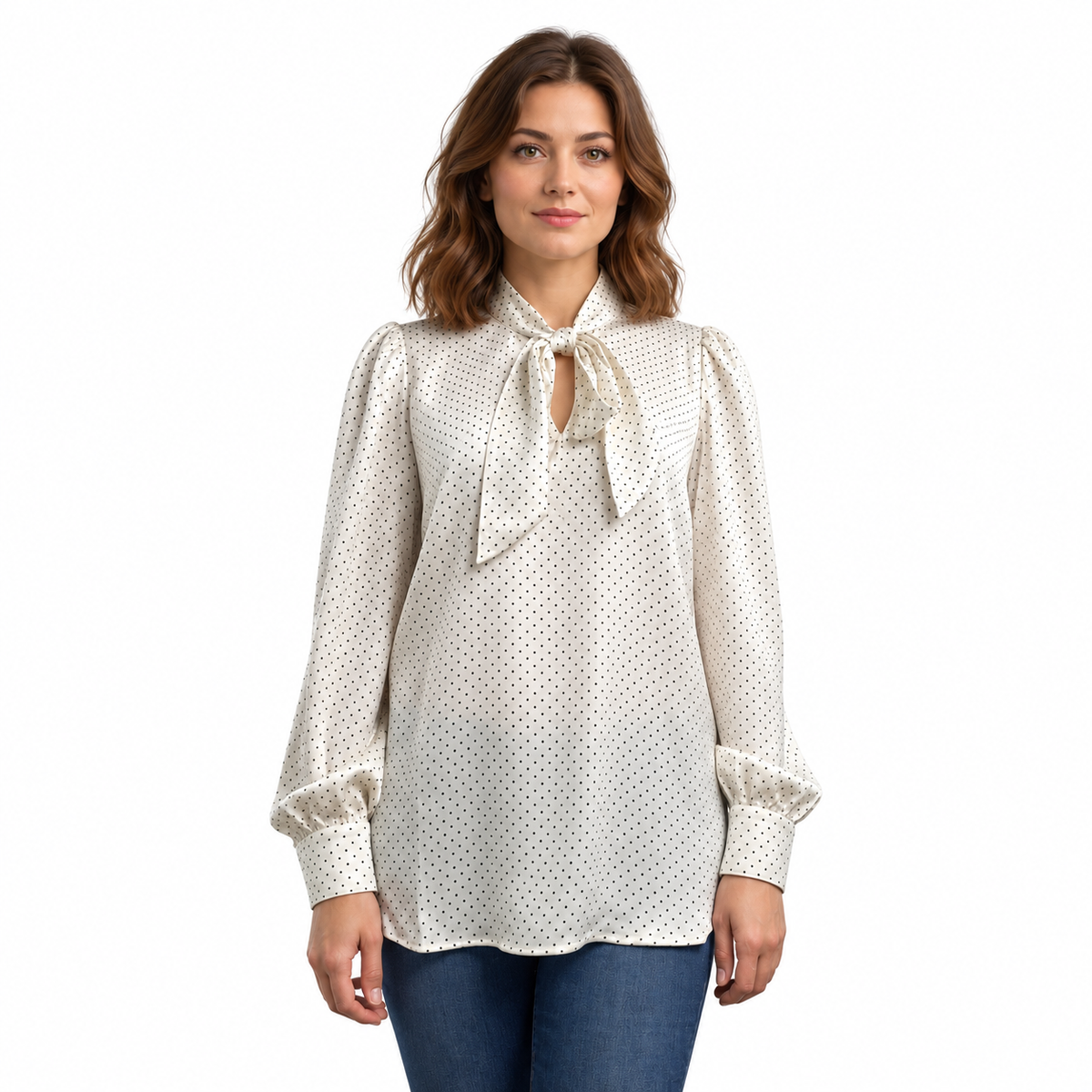 Front view of ivory satin tie-neck blouse with black pin dots, long gathered sleeves and a curved hem.
