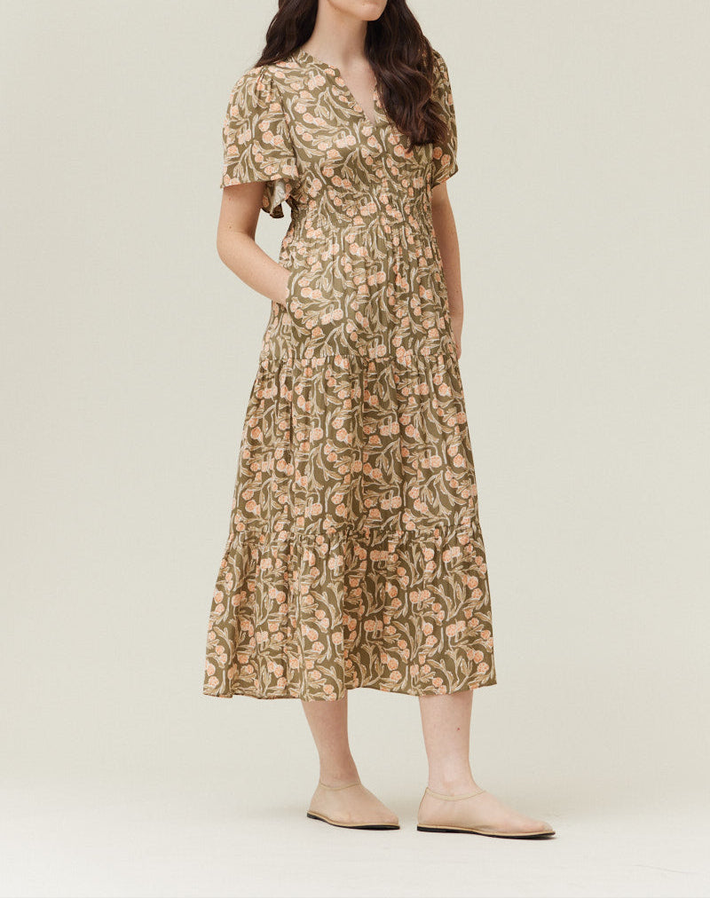 Woman wearing olive floral printed midi dress