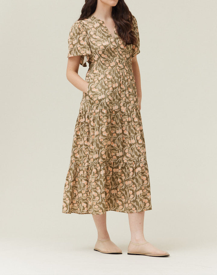 Woman wearing olive floral printed midi dress