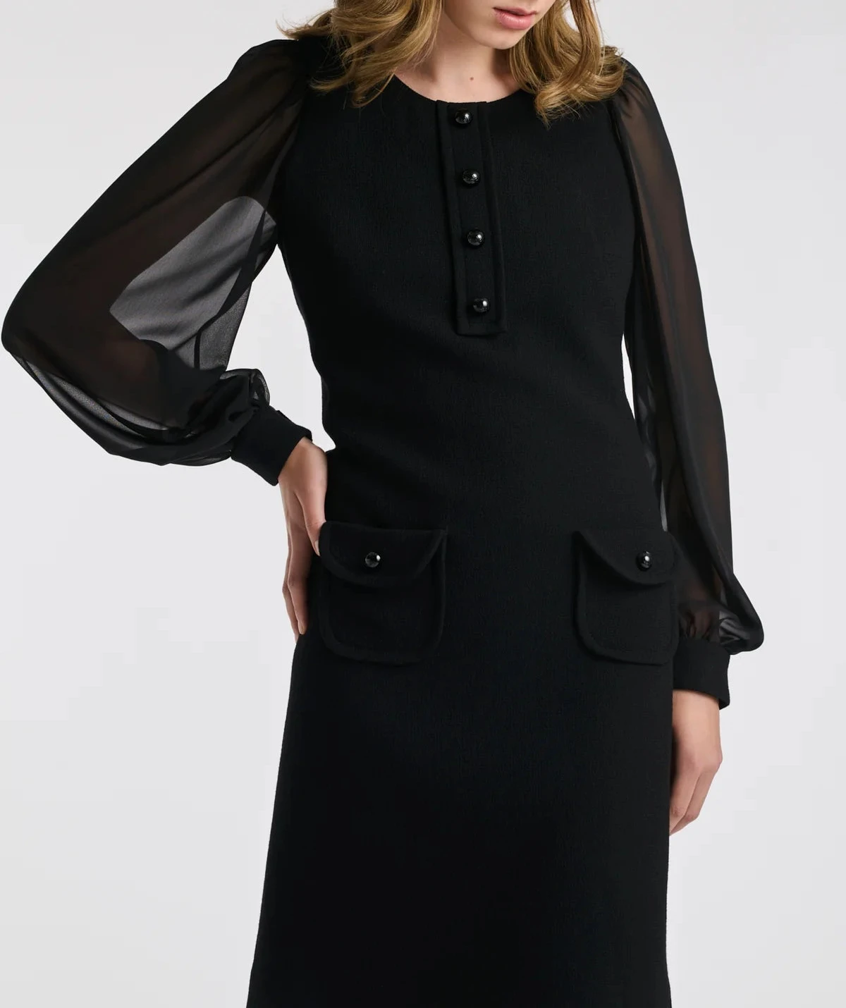 On‑model front: knee‑length black wool crêpe dress by Weill with sheer bishop sleeves, round neck and logo button placket