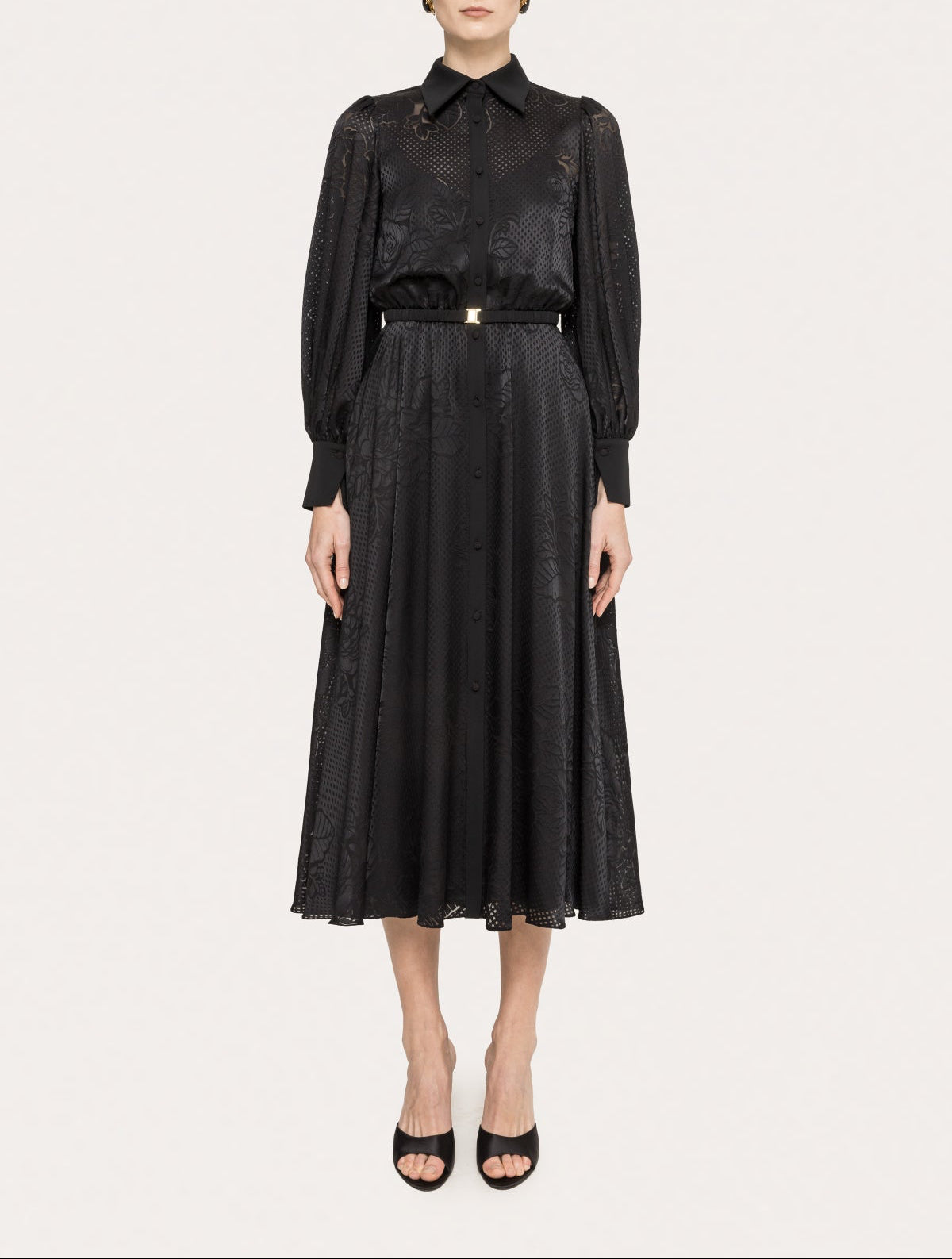 Front view of a black belted tonal floral midi cocktail dress with pointed collar, long blouson sleeves, and softly flared skirt