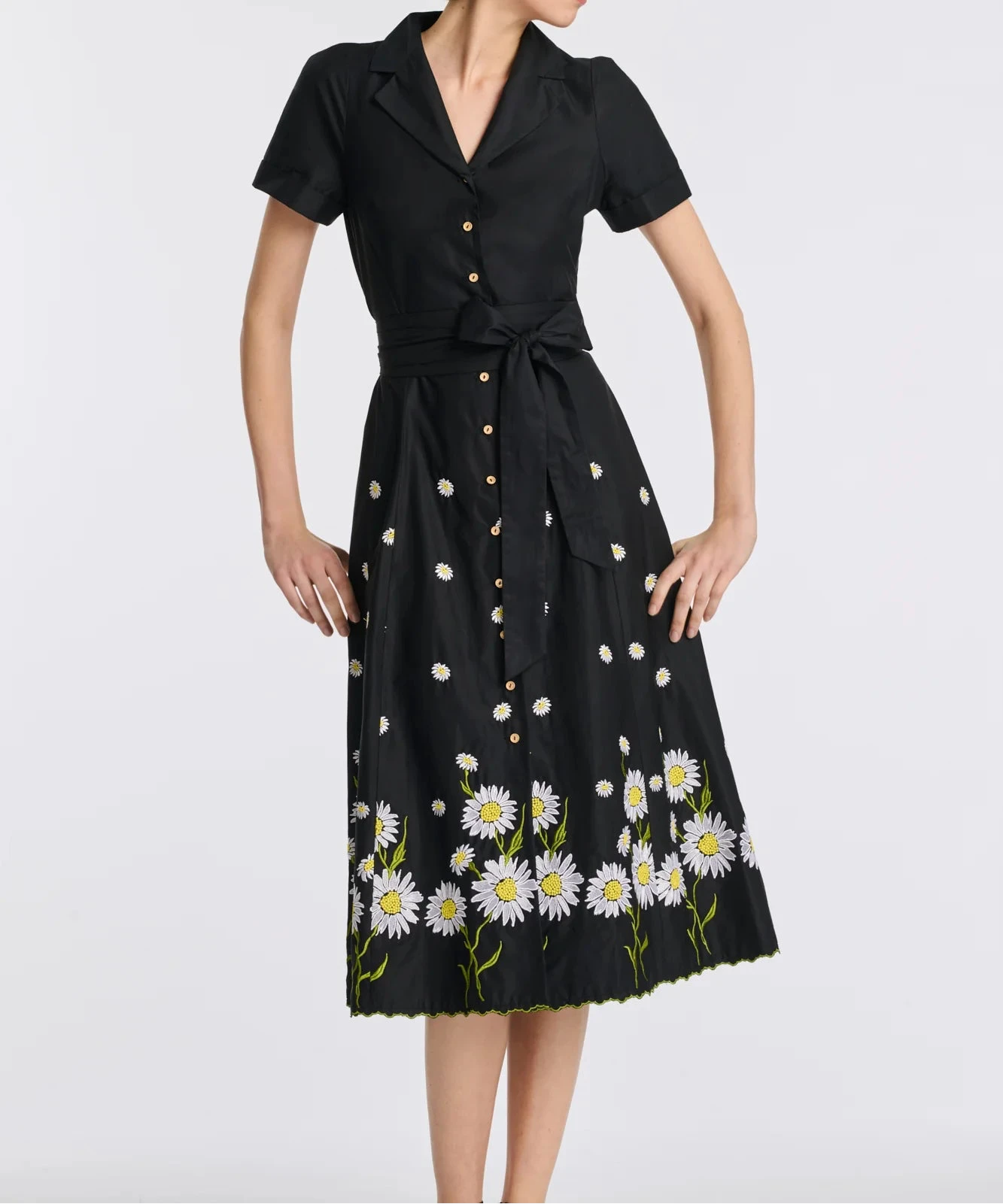 Full-length view of black cotton midi shirt dress with floral embroidery and removable belt on model