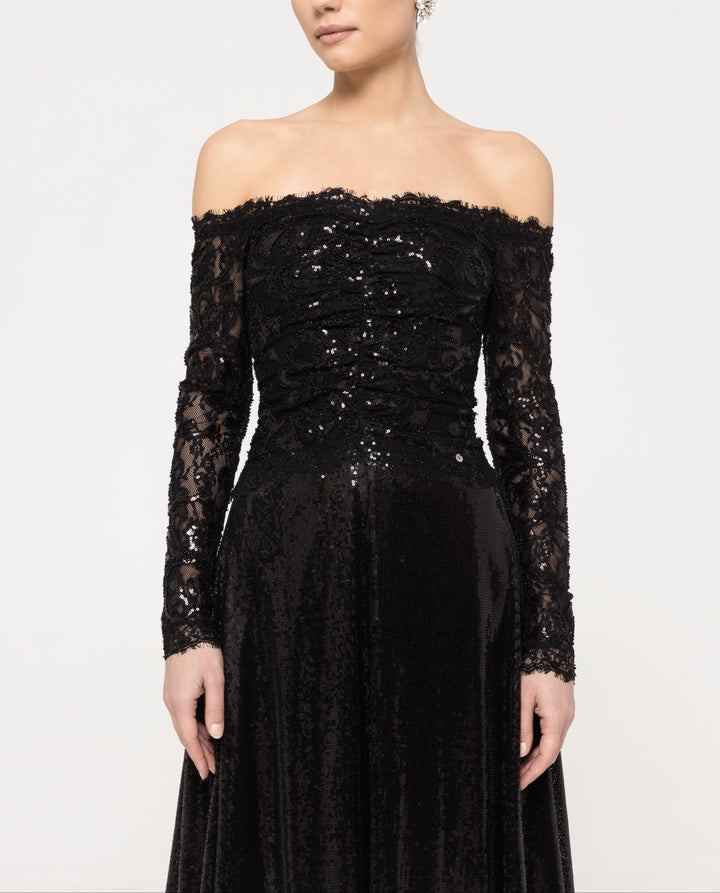 Close‑up of ruched, fully sequined lace bodice and sequined sheer long sleeve.