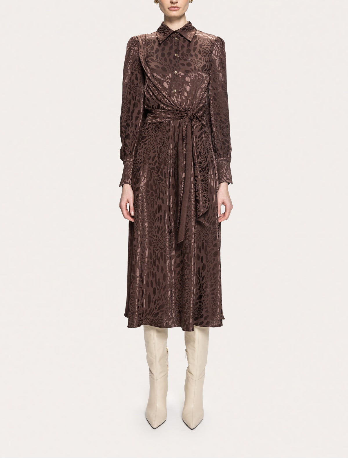 Front view of NISSA brown leopard print midi shirt dress with a buttoned bodice and self-tie waist, styled with cream boots.
