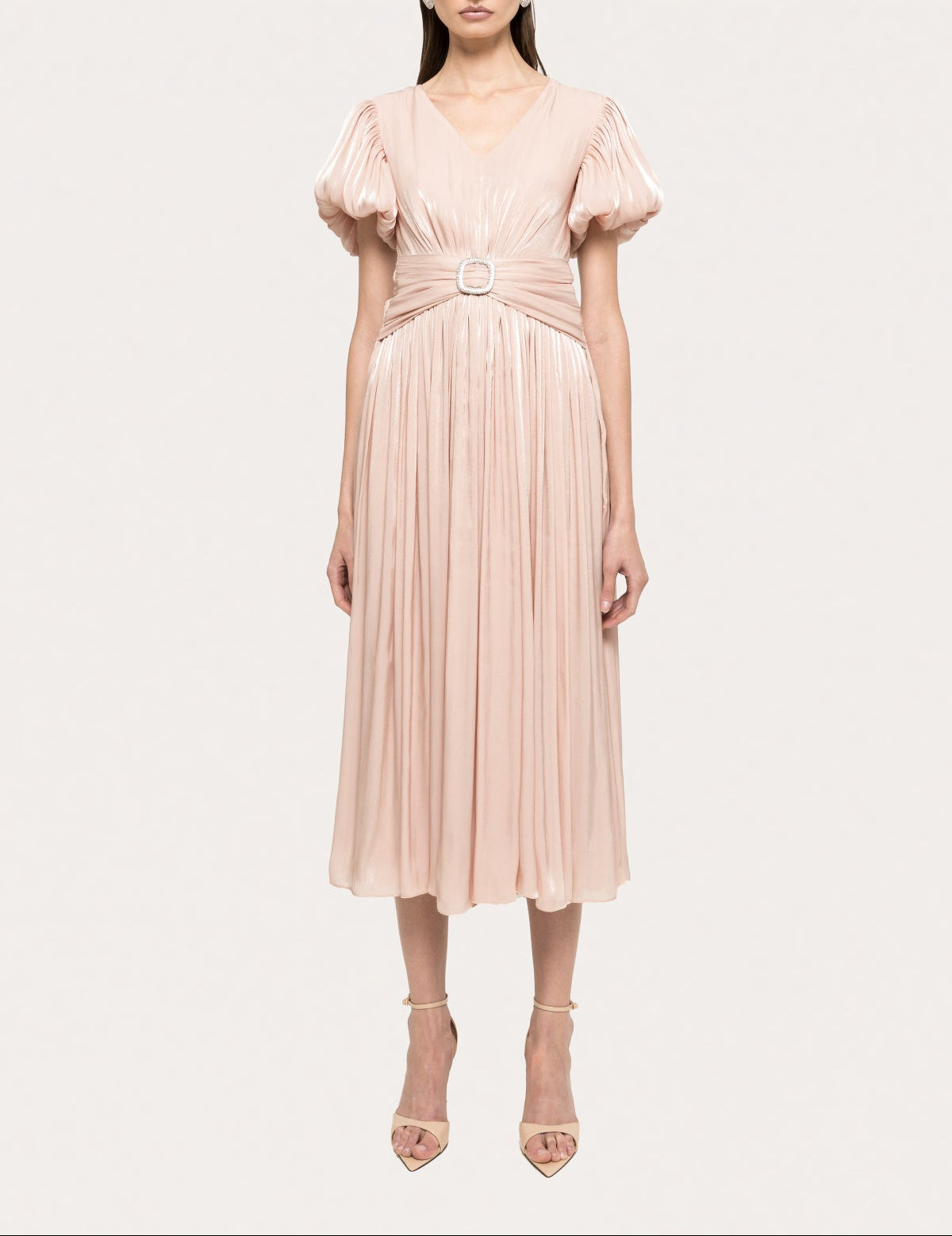 Blush metallic pleated midi dress with puff sleeves, deep V-neckline, fitted waist, and crystal buckle detail