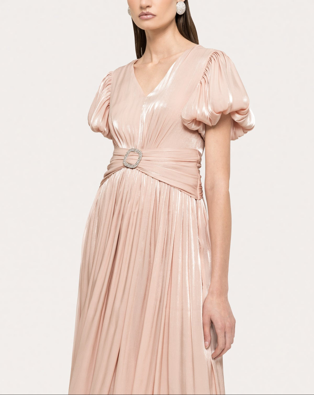 Close-up of deep V-neck blush formal midi dress with soft shimmer finish