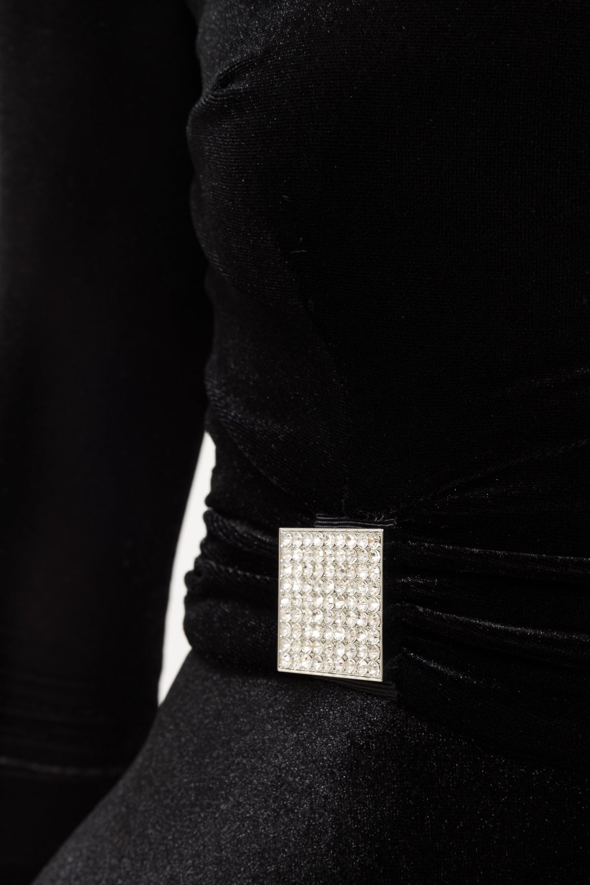 square crystal embellishment at gathered waist on black velvet