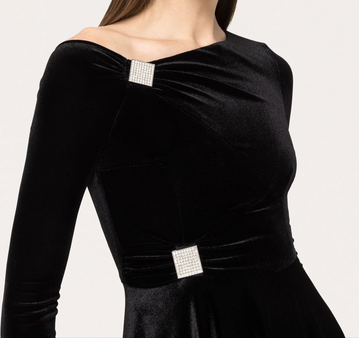 asymmetric off‑shoulder neckline with crystal square and gentle ruching