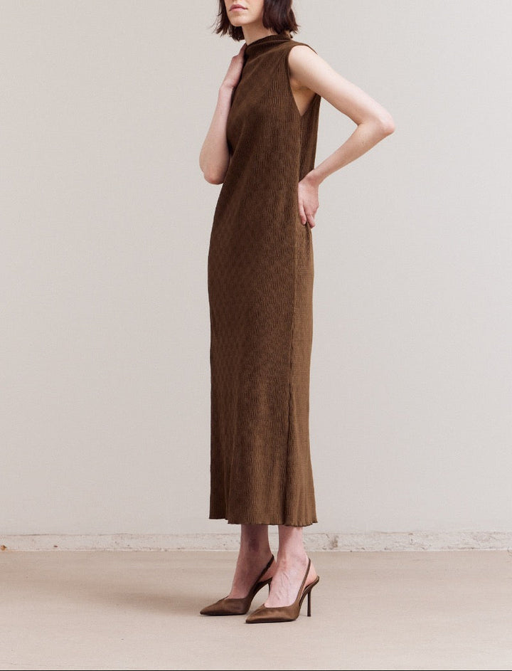 Angled view of the model in a dark moss crinkled velvet sleeveless midi dress, highlighting the mock neck and textured fabric.