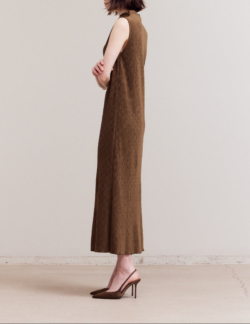 Side profile of a dark moss crinkled velvet sleeveless column dress, showing the clean straight fit and almost to ankle length.