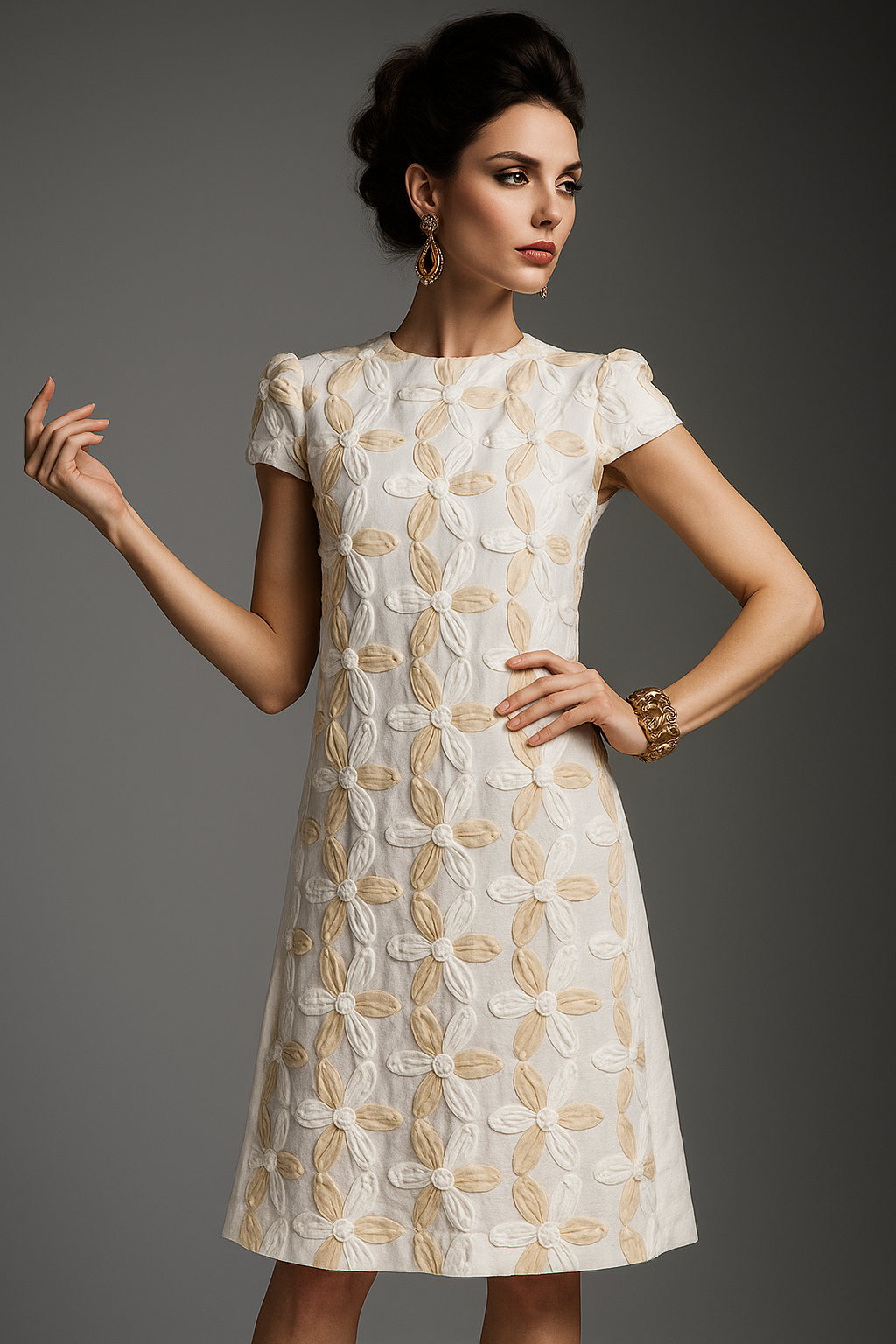 Woman wearing a white dress with gold patterns against a gray background