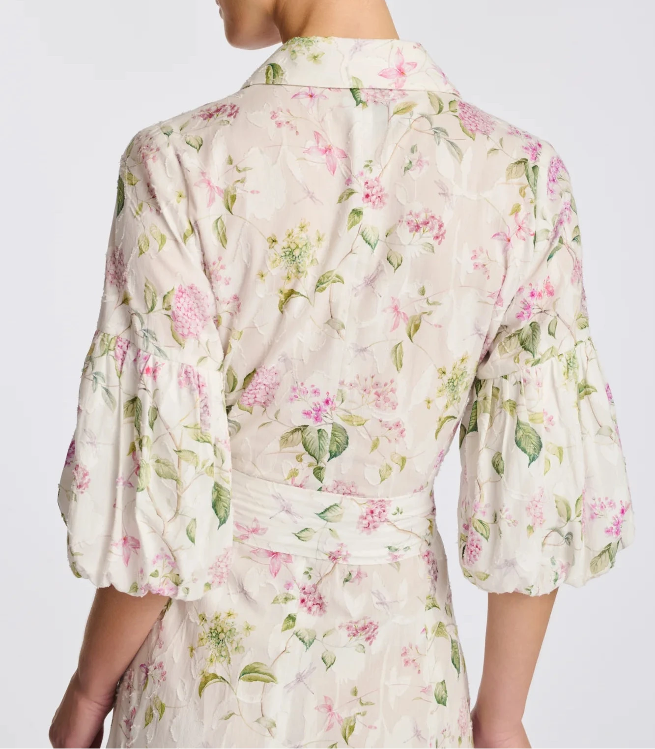 Back view of ivory floral cotton midi shirt dress with puff sleeves and waist tie
