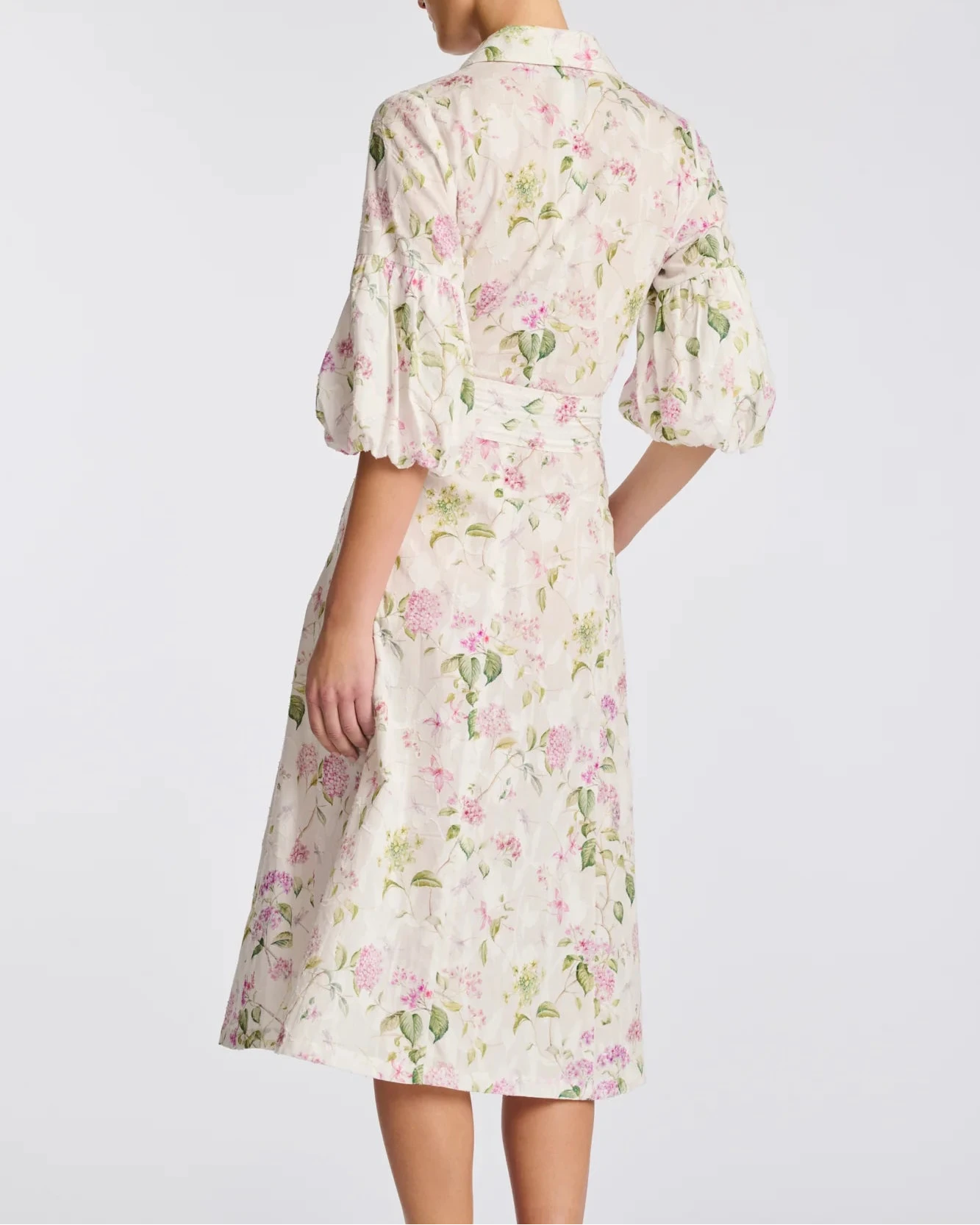 Back view of floral cotton midi shirt dress with puff sleeves and calf-length skirt