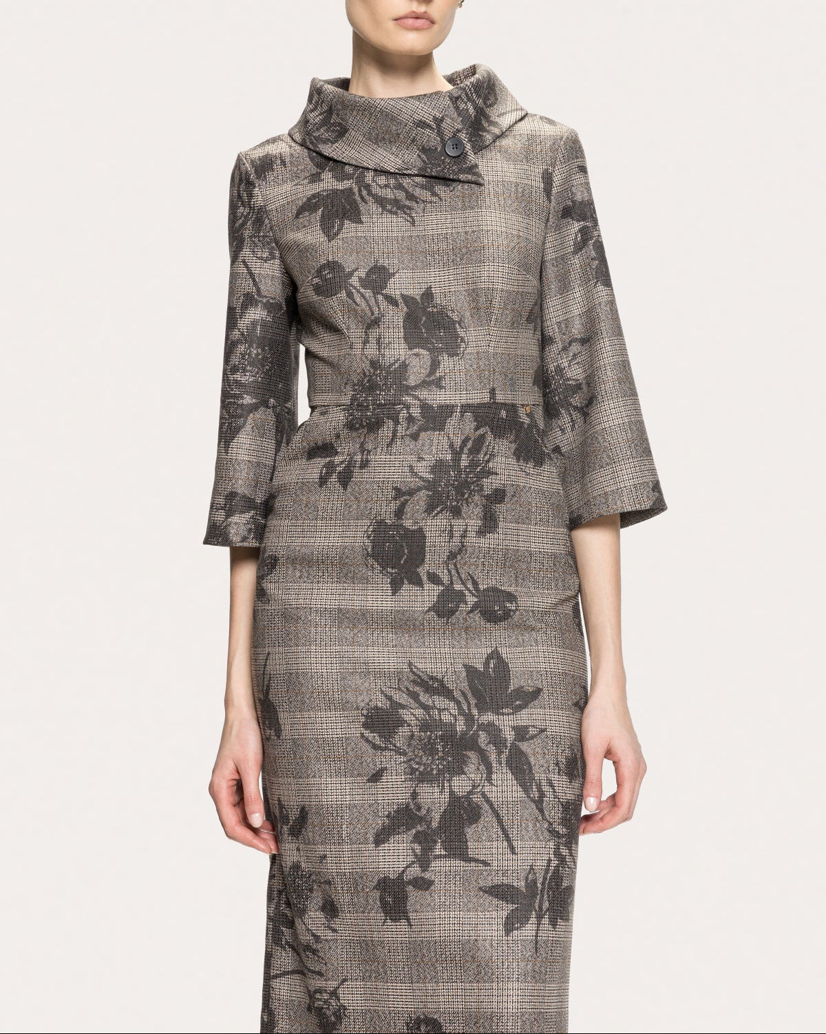 Front detail of NISSA gray plaid dress with black floral print, a fitted waist and asymmetric button collar.