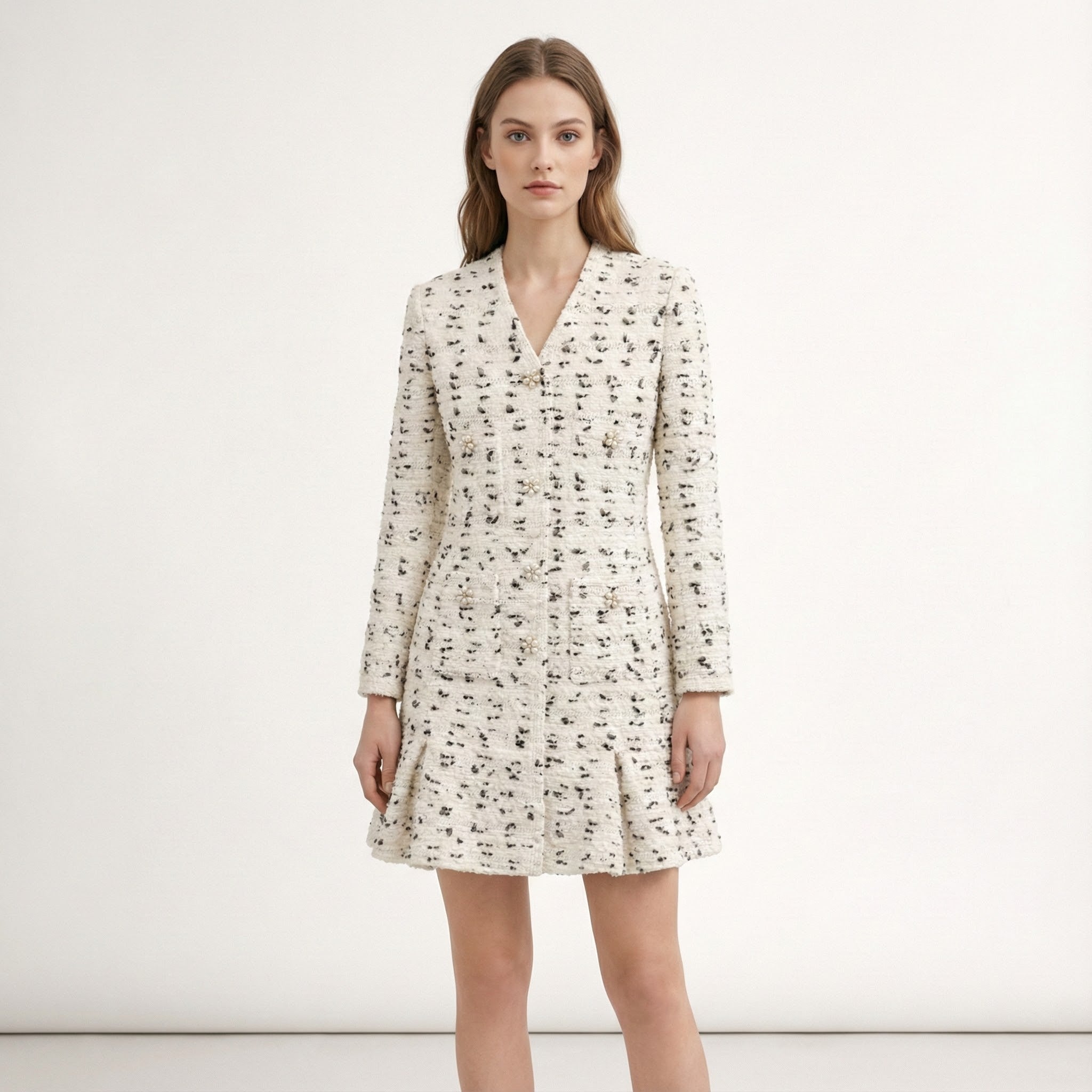 Woman wearing a white dress with black pattern on a white background