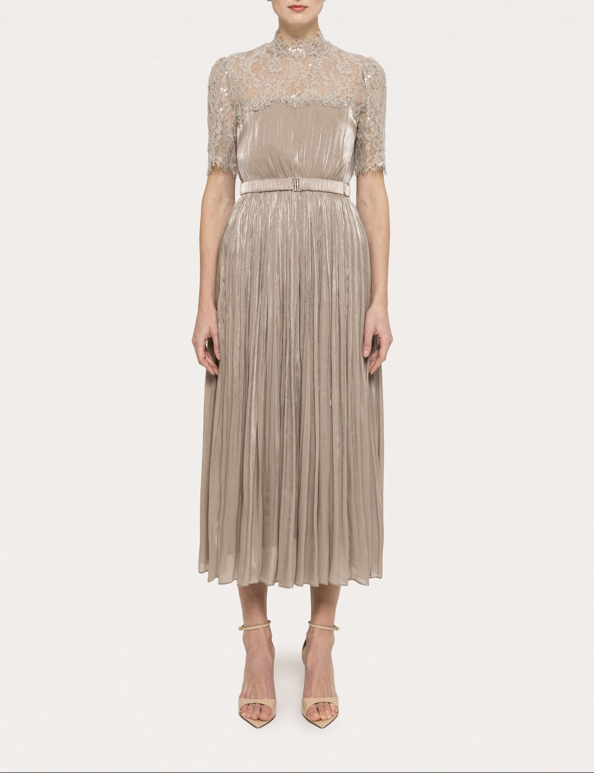 Model wearing a champagne lace high neck metallic pleated midi dress with belt and elbow-length lace sleeves