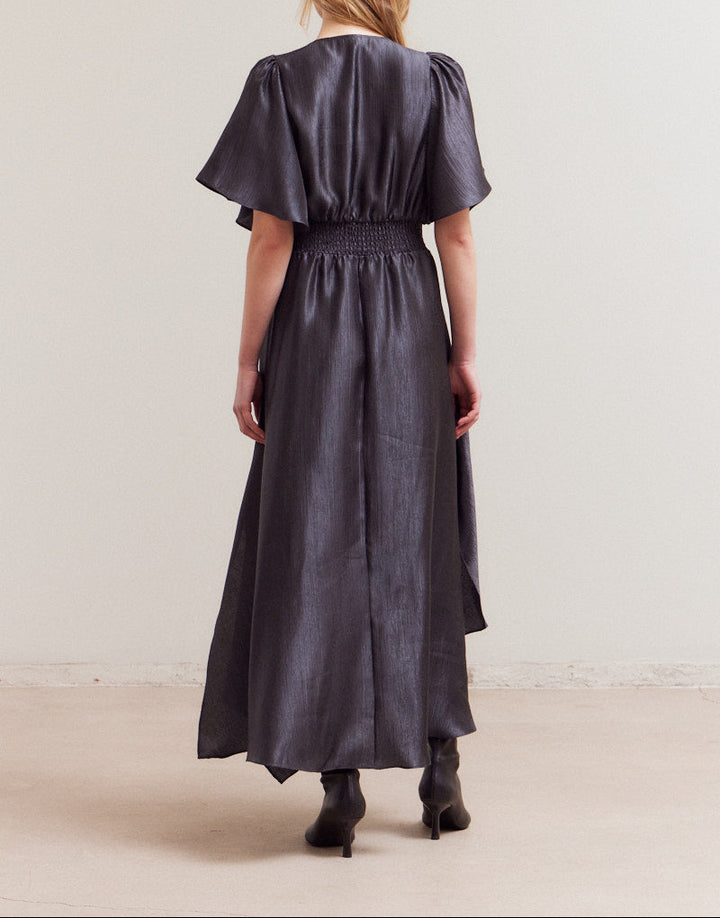 Back view of wrinkle satin maxi dress in deep midnight tone with shirred waist detail.